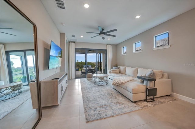 living room featuring light tile patterned flooring, plenty of natural light, and ceiling fan