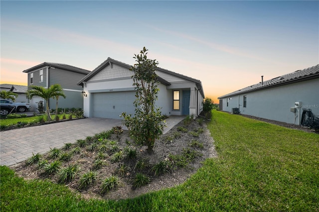 6237 Fish Eagle Ct, Nokomis, FL 34275 - view of front of house with decorative driveway, a yard, an attached garage, and stucco siding