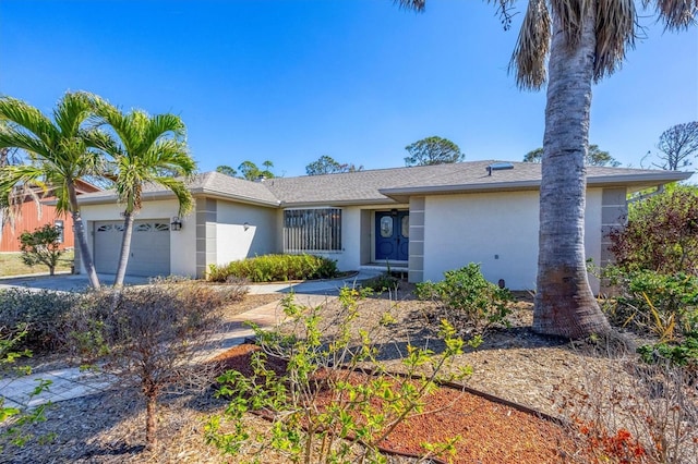 ranch-style house featuring stucco siding, concrete driveway, and an attached garage