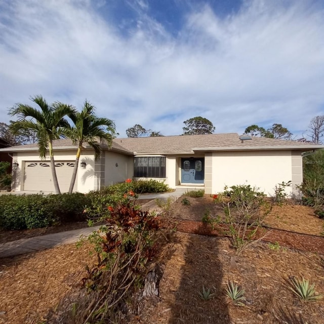 ranch-style home with stucco siding and a garage