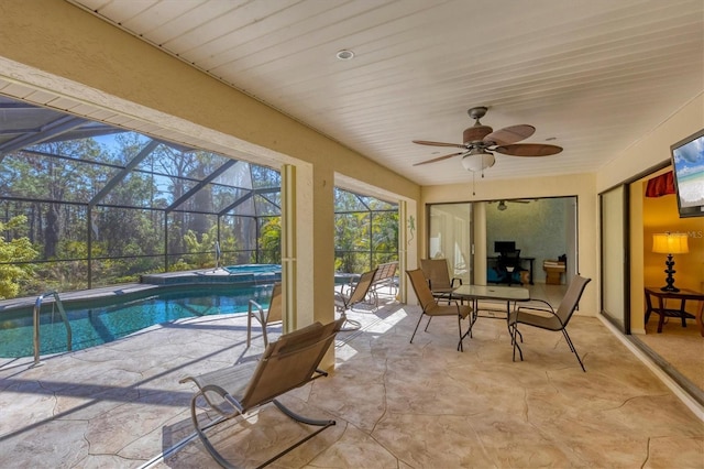 sunroom / solarium featuring a hot tub, ceiling fan, and a swimming pool