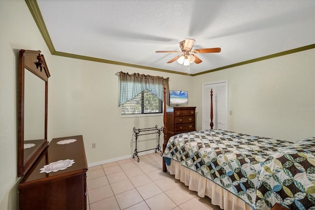 bedroom featuring a ceiling fan, a closet, baseboards, light tile patterned flooring, and ornamental molding