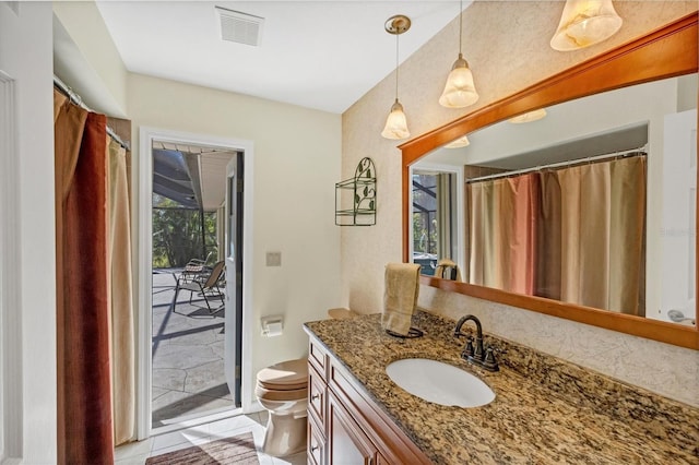 bathroom featuring vanity, toilet, visible vents, and tile patterned flooring