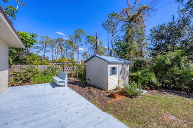 exterior space with an outbuilding, fence, and a storage unit