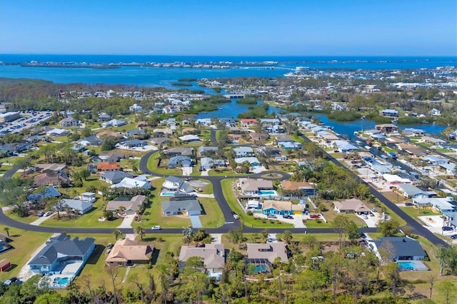 drone / aerial view with a water view and a residential view