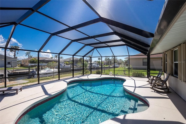 view of swimming pool featuring a patio area and glass enclosure