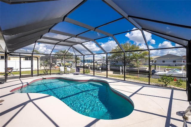 view of swimming pool featuring glass enclosure and a patio area