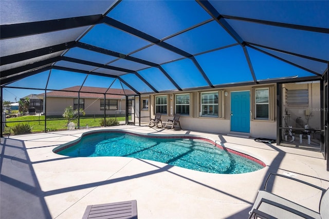 view of swimming pool featuring a lanai and a patio