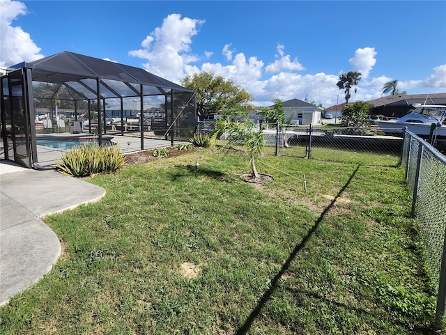 view of yard featuring a fenced in pool, a patio area, and glass enclosure