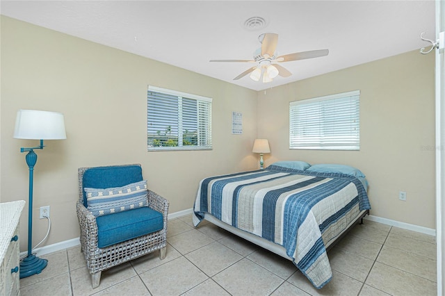 tiled bedroom featuring ceiling fan