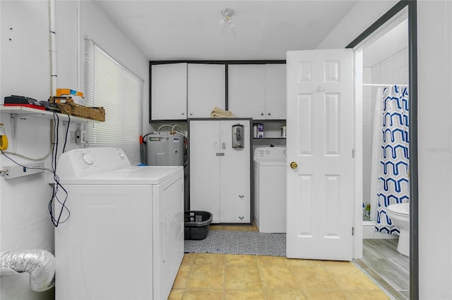 washroom featuring cabinets, washer / dryer, and electric water heater