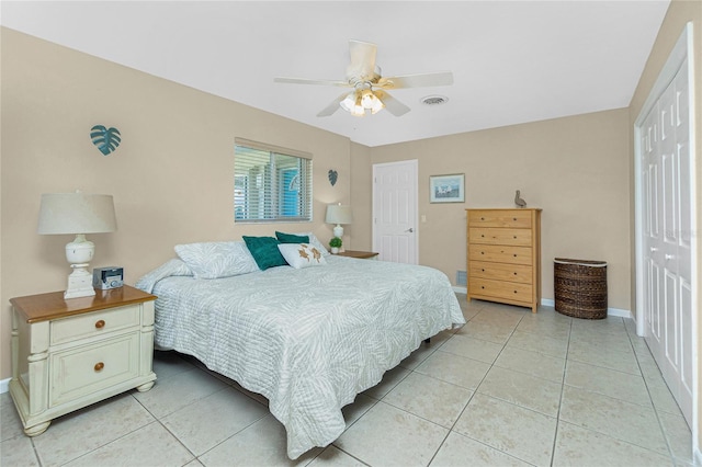 bedroom with light tile patterned floors, ceiling fan, and a closet