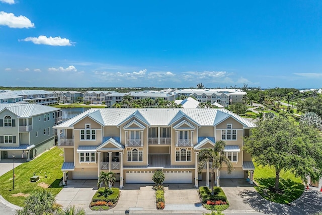 view of front of property with a garage and a water view