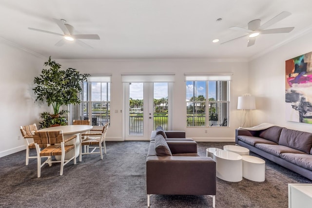 living room featuring ceiling fan, ornamental molding, and dark colored carpet