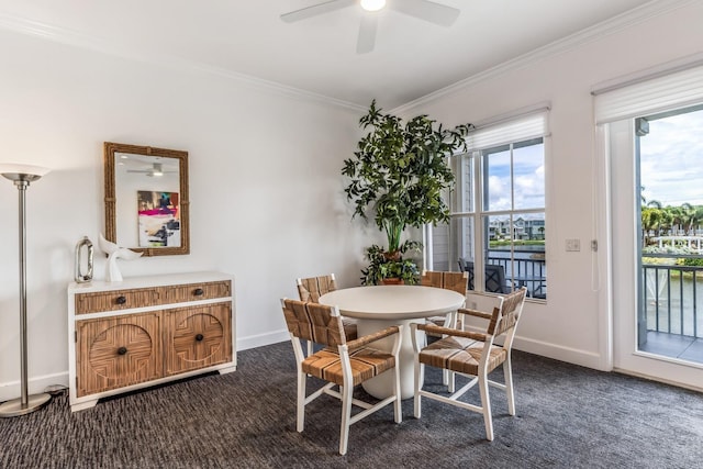 carpeted dining space with ornamental molding and ceiling fan