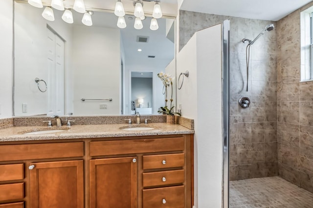 bathroom featuring vanity and tiled shower