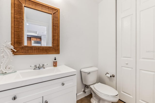 bathroom featuring vanity and toilet