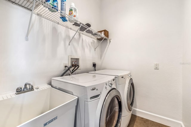 clothes washing area featuring tile patterned floors, sink, and washing machine and dryer