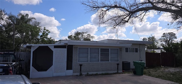 view of front of property featuring cooling unit and a patio