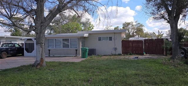 exterior space with a lawn and central air condition unit