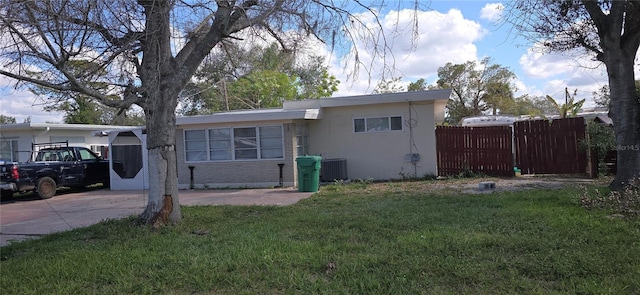 view of front facade with central AC and a front lawn