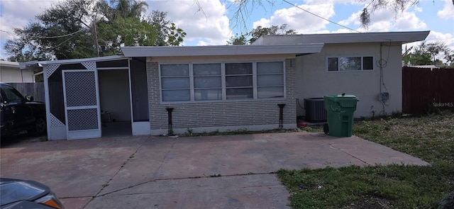 rear view of house with central AC and a patio area