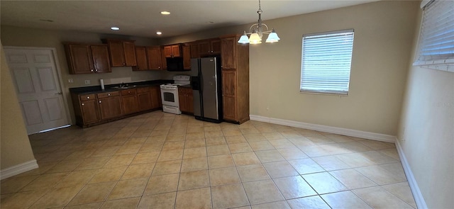 kitchen with pendant lighting, white electric range, sink, stainless steel fridge, and an inviting chandelier