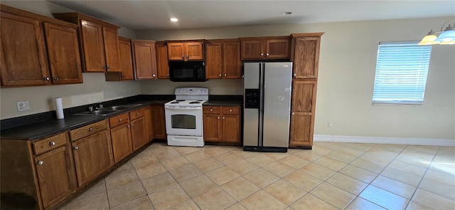 kitchen featuring stainless steel fridge with ice dispenser, light tile patterned flooring, sink, and white range with electric stovetop