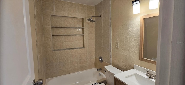 full bathroom featuring vanity, toilet, and tiled shower / bath combo