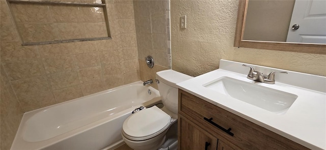 full bathroom featuring tiled shower / bath combo, vanity, and toilet