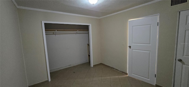 unfurnished bedroom featuring ornamental molding, a closet, and a textured ceiling