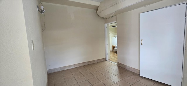 unfurnished room featuring light tile patterned floors