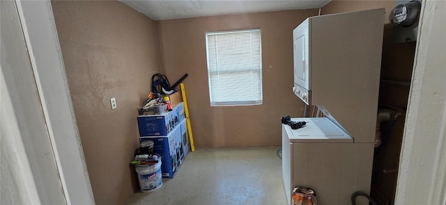 clothes washing area with stacked washer and dryer