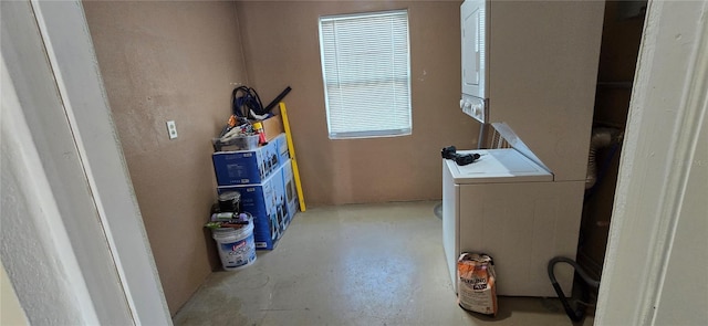 clothes washing area featuring stacked washer / drying machine