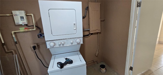 laundry area featuring stacked washer and dryer and electric panel