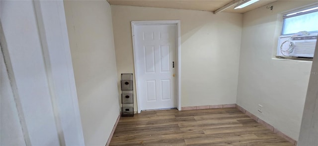 spare room featuring cooling unit and light wood-type flooring