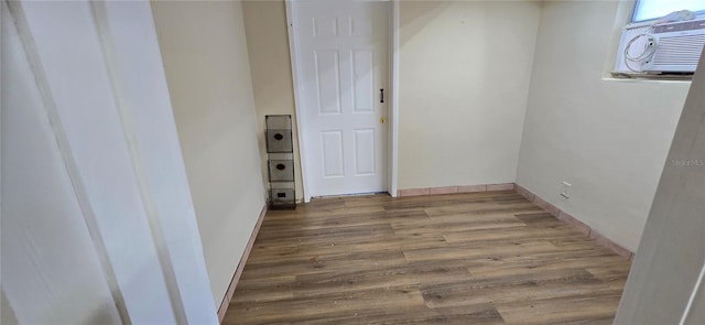 interior space featuring a wall mounted AC and light wood-type flooring