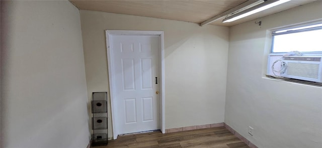 spare room featuring cooling unit and wood-type flooring