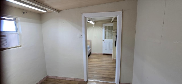 corridor with wood-type flooring