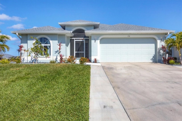 view of front facade featuring a shingled roof, concrete driveway, stucco siding, an attached garage, and a front yard