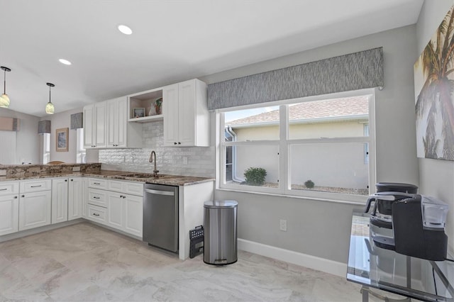 kitchen with a sink, stone countertops, white cabinetry, and dishwasher