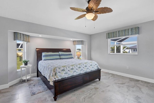 bedroom featuring ceiling fan and baseboards