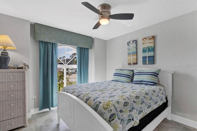 bedroom with a ceiling fan and baseboards