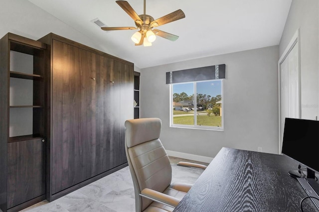 office featuring lofted ceiling, visible vents, a ceiling fan, baseboards, and marble finish floor