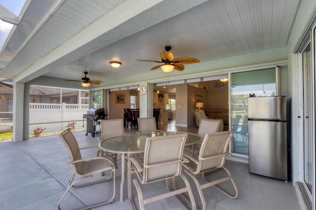 view of patio / terrace featuring ceiling fan, outdoor dining area, fence, and a grill