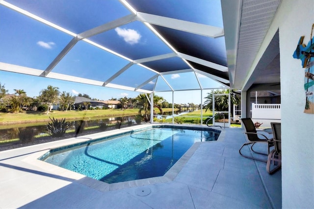 outdoor pool with a patio area, a water view, and a lanai