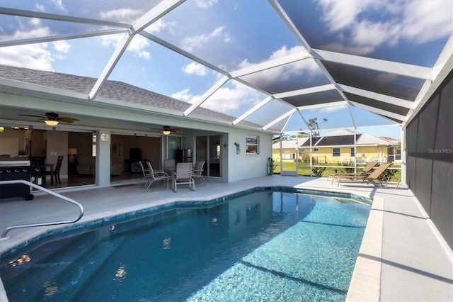 pool with ceiling fan, a patio, and glass enclosure