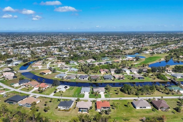 birds eye view of property featuring a water view and a residential view