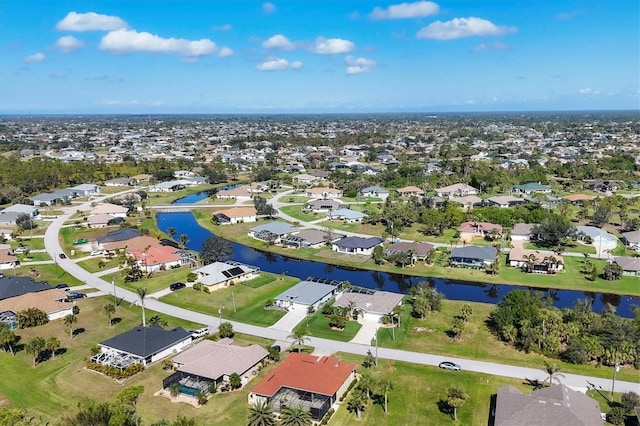 birds eye view of property with a water view and a residential view