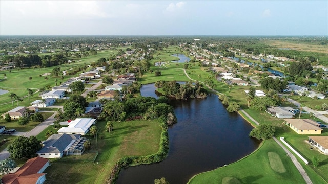 aerial view with golf course view, a water view, and a residential view